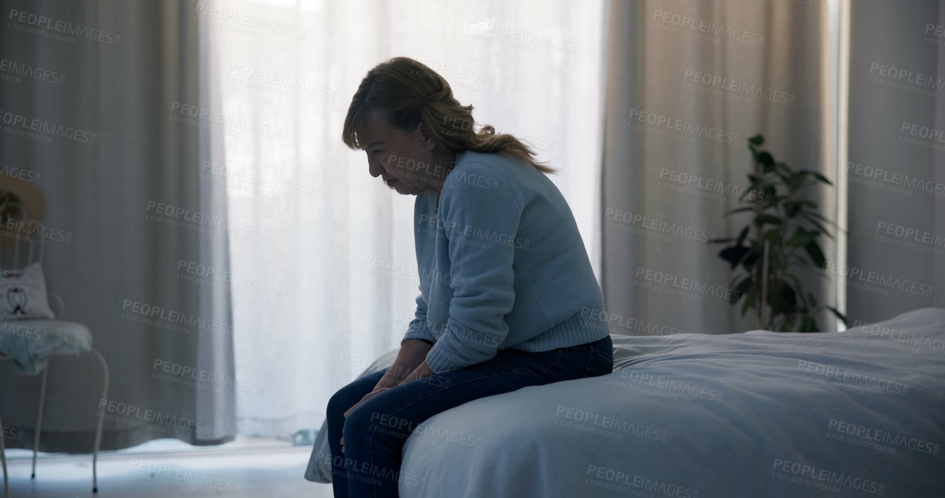 Buy stock photo Crying, depression and sad woman in bedroom with anxiety, mental health problem or debt in retirement. Lonely, worried and frustrated senior female person at home with headache, fatigue or bad crisis