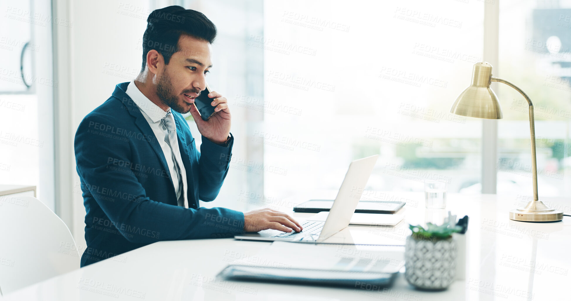 Buy stock photo Business man talking, phone call and laptop at desk, networking or reading info. Computer, smartphone and lawyer in conversation, communication or working on research, typing email and chat in office