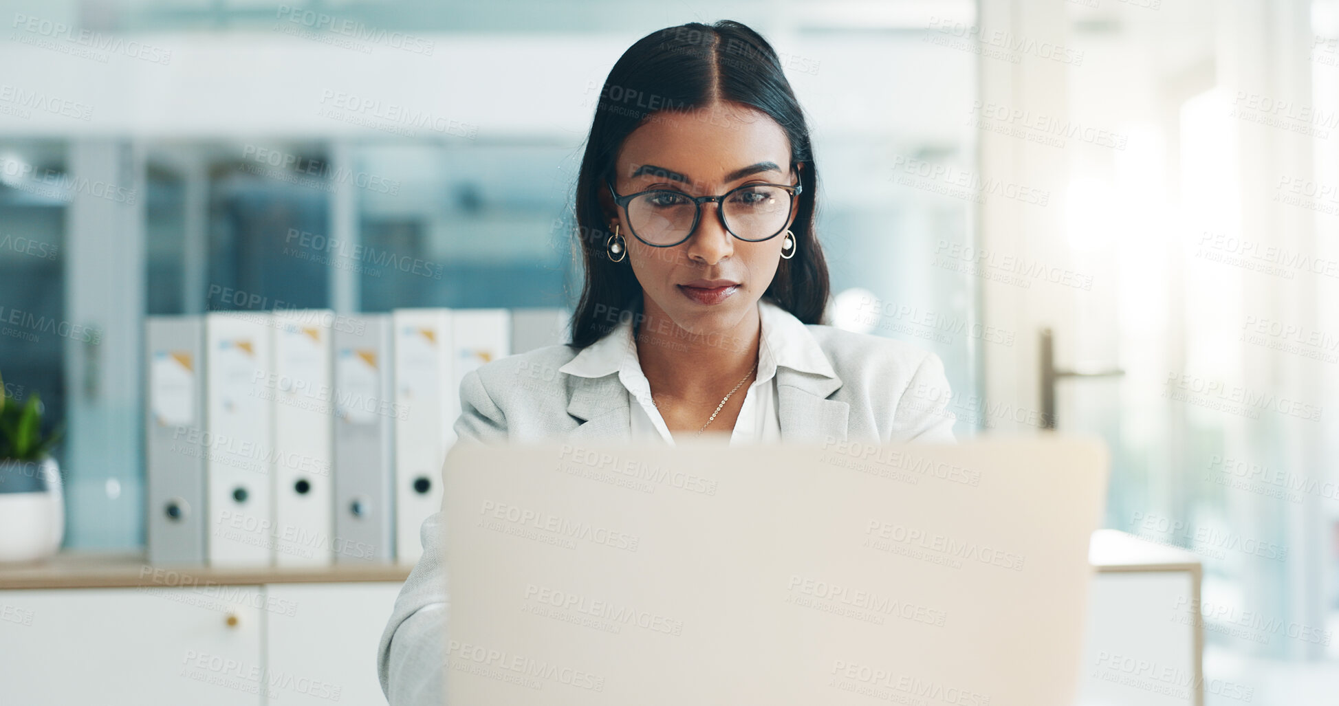 Buy stock photo Glasses, laptop and business woman in office doing research for legal information for project. Technology, focus and female attorney working on a corporate law case with computer in modern workplace.