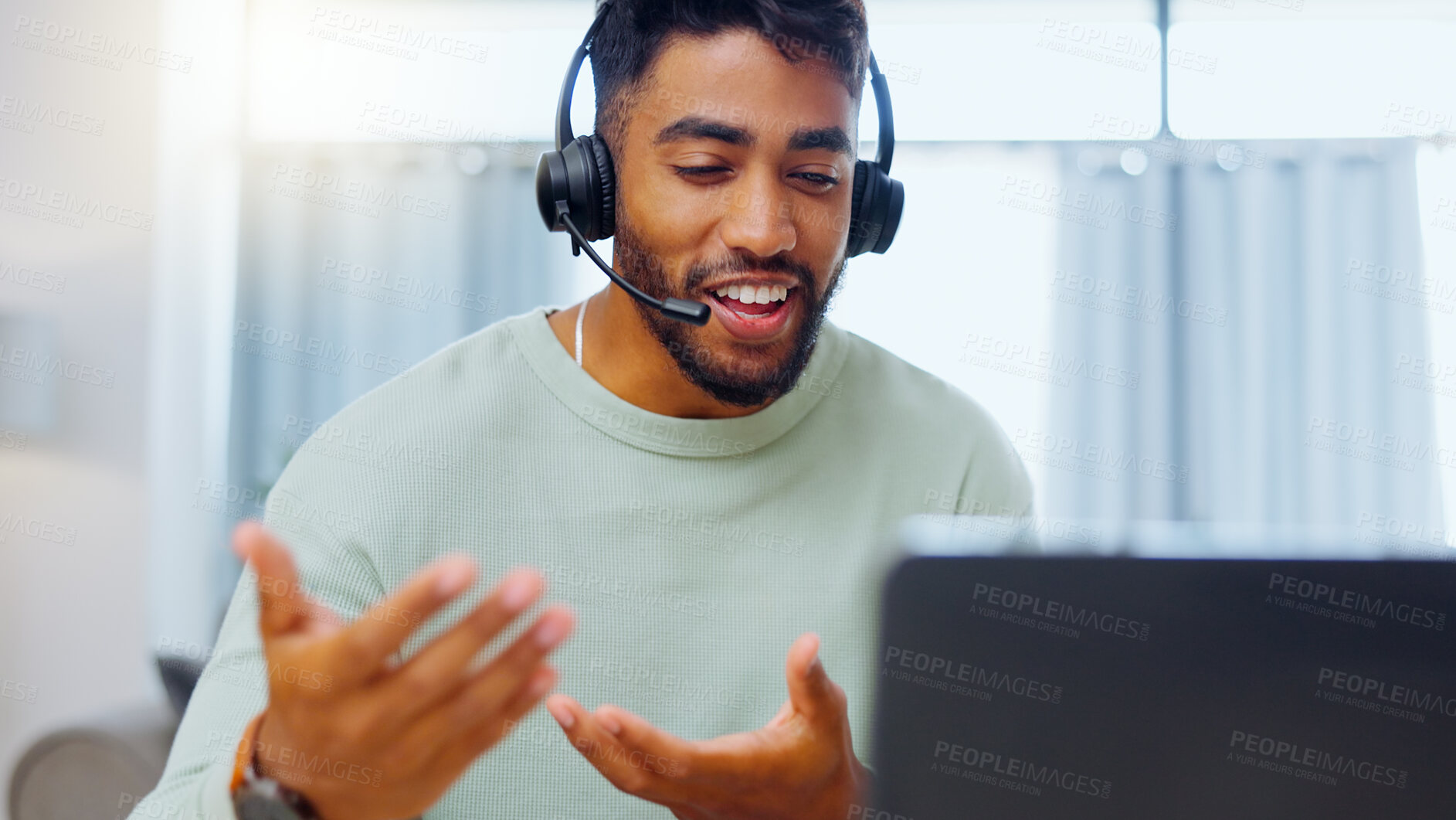 Buy stock photo Video call, black man and work from home, virtual communication or remote client tech support in call center career. Hello, wave of indian person, agent or consultant in living room on laptop talking