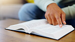 Prayer, reading and bible with man in living room for worship, spiritual and Christian faith. Hope, God and belief with person praying with holy book at home for religion, thinking and gratitude