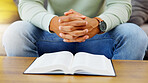 Prayer, peace and bible with hands of person in living room for worship, spiritual and Christian. Hope, God and belief with closeup of man with holy book at home for religion, praying and gratitude