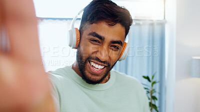 Selfie, man and smiling with headphones for music playlist streaming and cheerful mood in home. Wellness laughing, audio and happy male ready to dance photograph with smile.