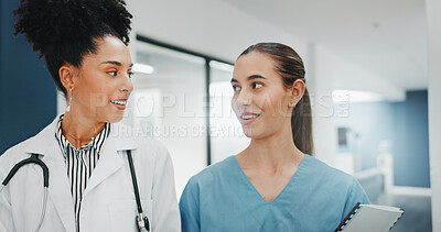 Women doctors, talking or walking in hospital in teamwork, nurse collaboration or surgery research. Smile, happy or healthcare workers in planning, communication or discussion for medicine treatment