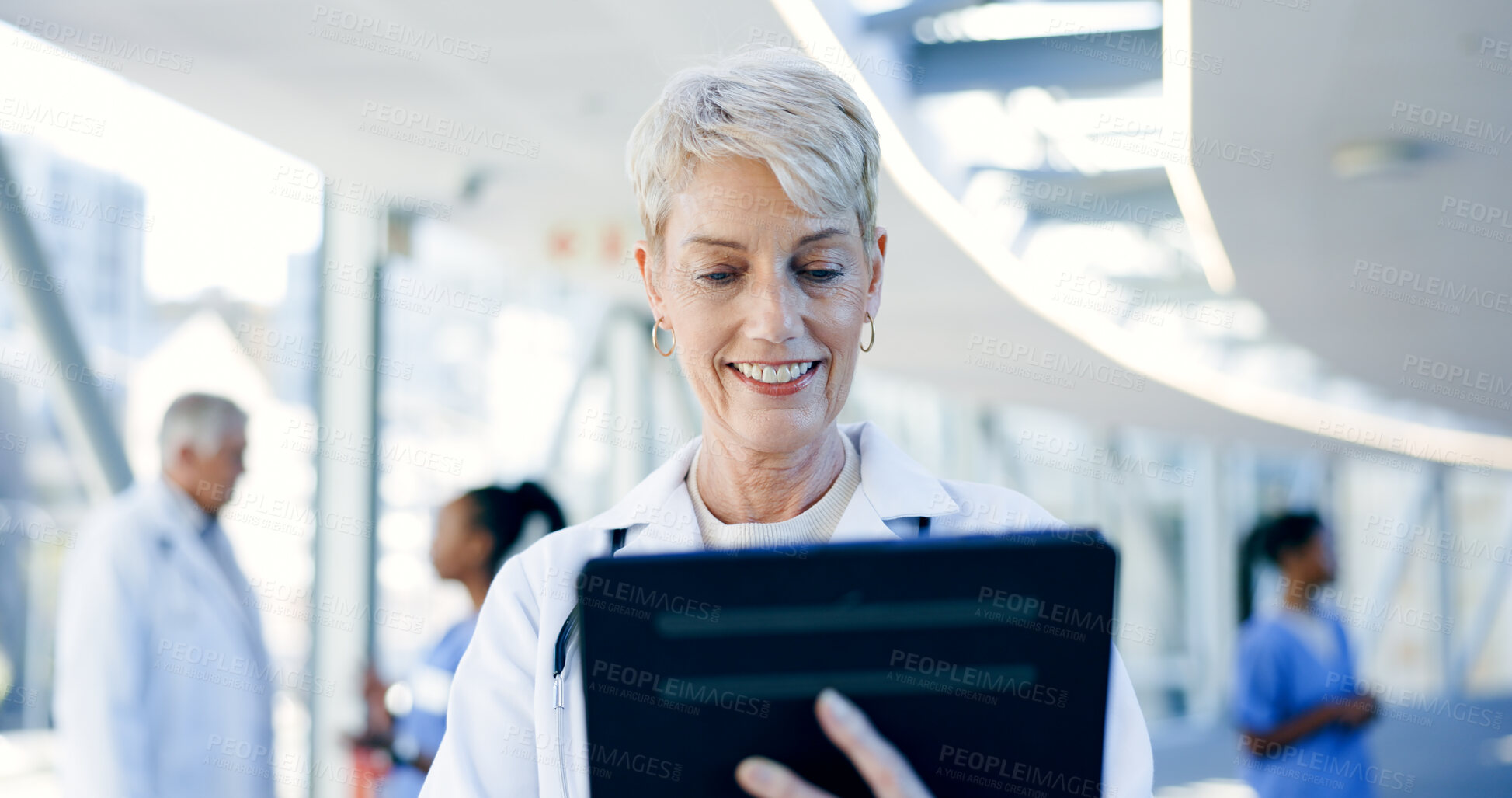 Buy stock photo Healthcare, tablet and senior woman doctor smile in a lobby with research, planning or email. Digital, app and elderly female nurse online in hospital for Telehealth, social media or reading feedback