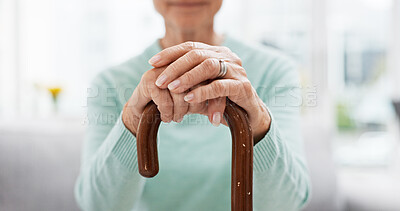 Hands, walking stick and elderly woman with walking stick on a sofa for balance, support and mobility. Walk, aid and old female at senior care facility with disability, dementia or chronic arthritis