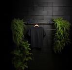 Black t-shirt mockup with copyspace on dark background on hanger, front view