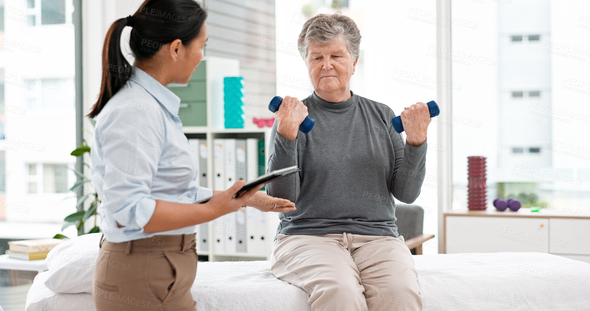 Buy stock photo Physical therapy, senior patient with dumbbells and chiropractor with tablet, monitor progress and exercise. Help, support and women at clinic, weightlifting and elderly care with health and physio