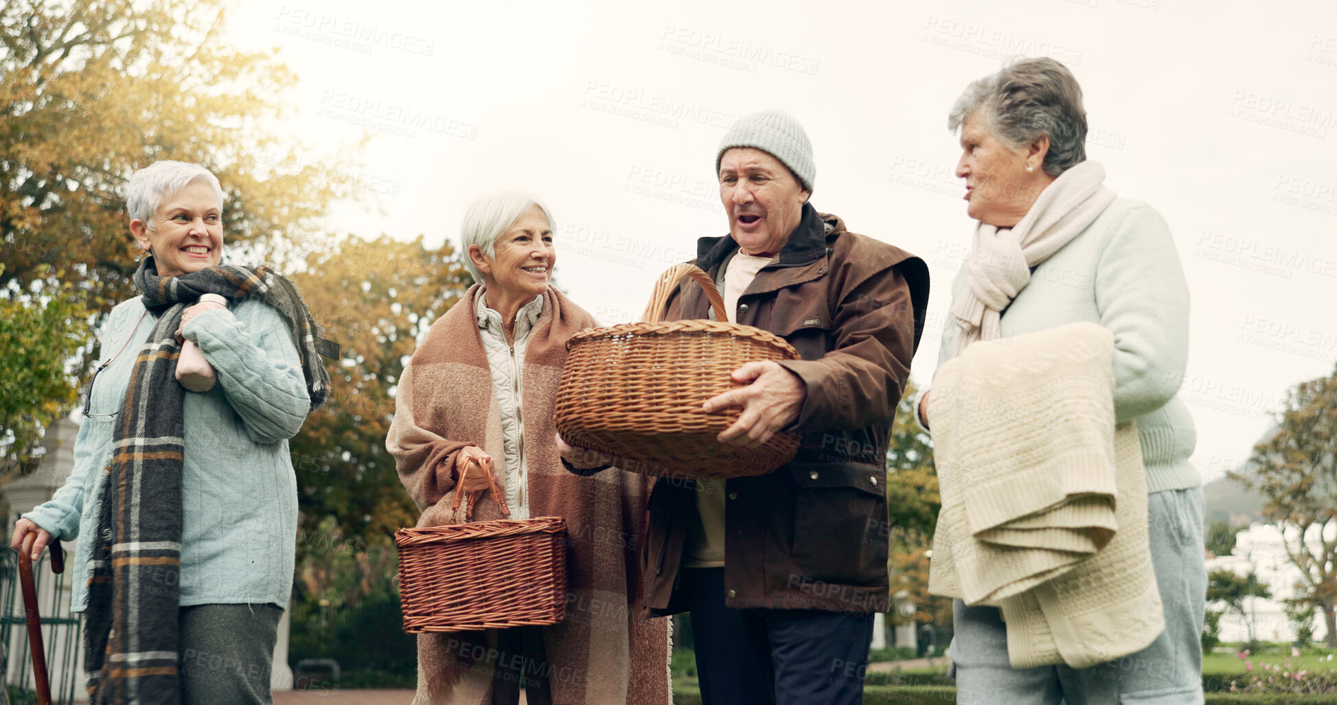 Buy stock photo Walking, picnic and senior friends in the park together for bonding or conversation during retirement. Smile, basket and a group of happy elderly people in a garden for freedom, fresh air to relax