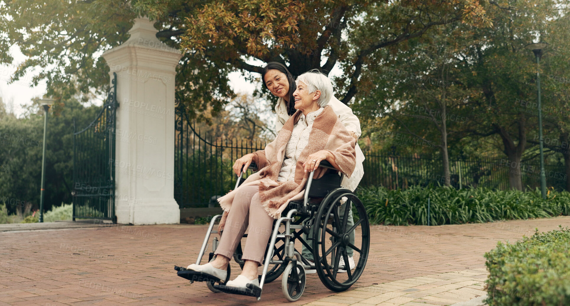 Buy stock photo Senior woman, wheelchair and caregiver in park, nature or garden outdoor together. Happy, elderly person with a disability and walking for health, wellness and physical therapy for rehabilitation