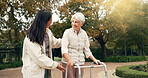 Park, walker and woman help senior walking as support, trust and care for morning healthcare exercise or workout. Health, physical therapy and elderly with caregiver for outdoor rehabilitation