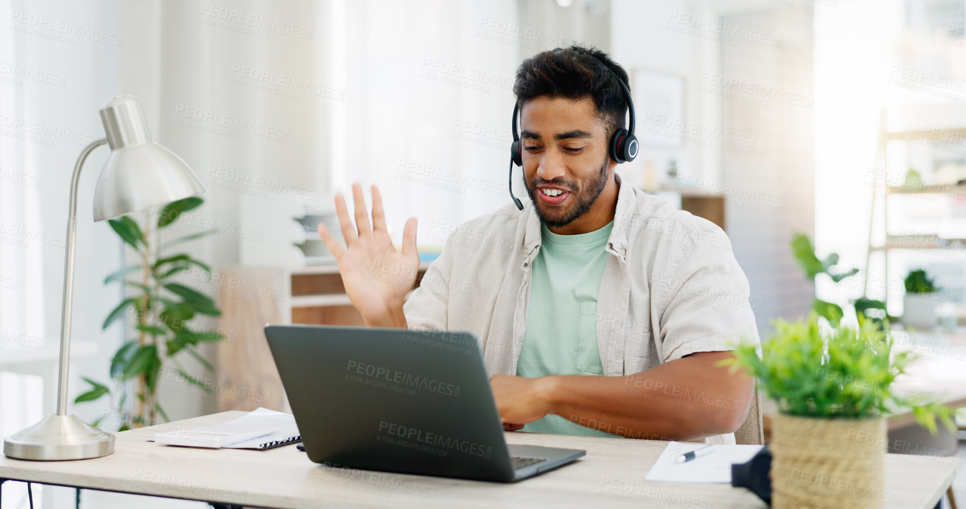 Buy stock photo Headphones, man and laptop for webinar, greeting and conversation in living room. Male, guy and person with device, headset and online conference for training, virtual chat and wave to start meeting