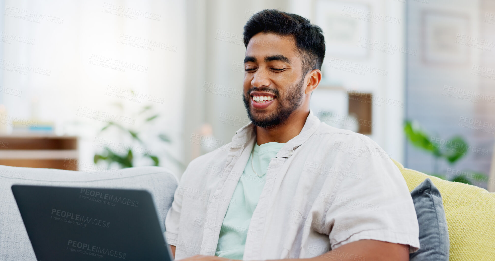 Buy stock photo Laptop, laughing and man on couch watching funny video, live streaming or reading post on social media. Happy person relaxing on sofa with computer, internet and wifi in his apartment or living room