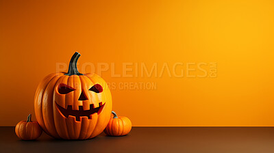 Carved halloween pumpkin on orange copyspace background. Evil Jack-o-lantern face