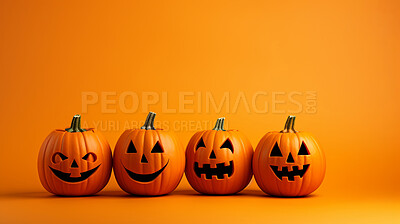 Row of carved halloween pumpkins on orange copyspace background.