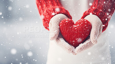 Hands holding knitted red heart on snowy copyspace. Love, friendship concept