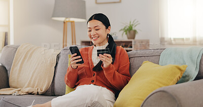 Happy woman, credit card and phone on couch online shopping, ecommerce and fintech easy payment. Asian person in China typing bank information on cellphone for discount or finance transaction at home