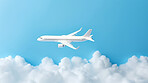 Airplane on blue copyspace background with clouds. Sustainable travel, zero emissions travel concept