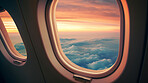 Airplane window with clouds and sunlight. International luxury travel concept