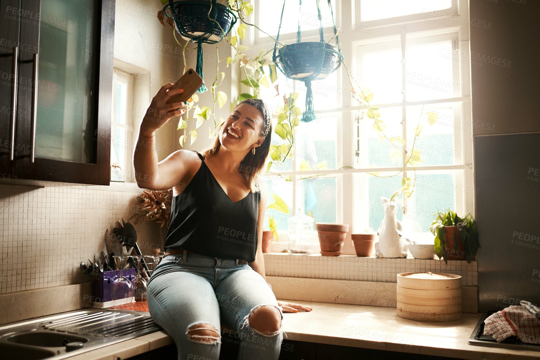 Buy stock photo Talking on phone video call, waving and greeting while communicating, chatting and networking during lockdown. Smiling, happy and cheerful woman or vlogger using hand gesture and filming vlog at home