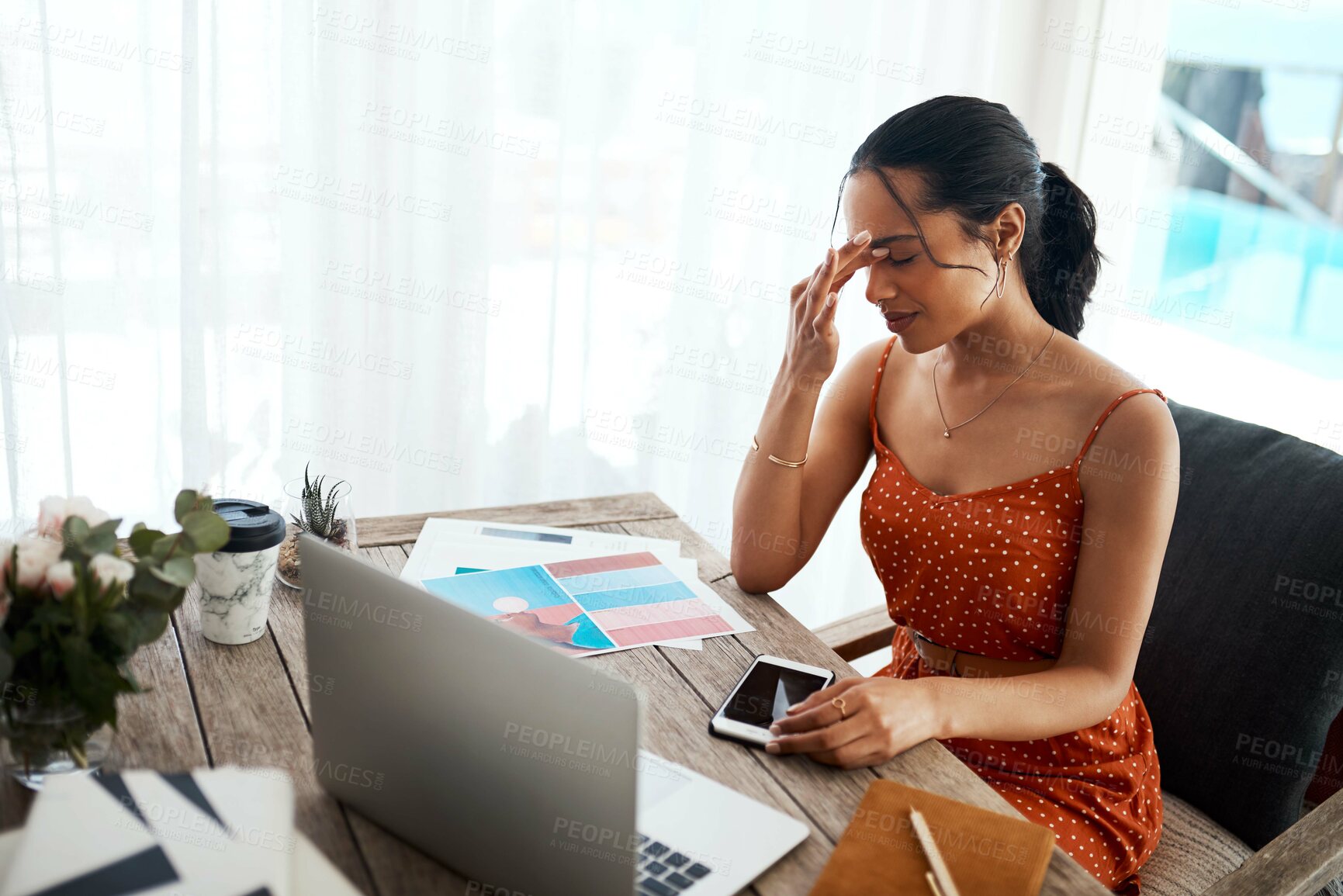 Buy stock photo Cropped shot of an attractive young businesswoman sitting in her home office alone and suffering from a headache