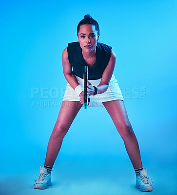 Buy stock photo Full length portrait of an attractive young female tennis player posing against a blue background