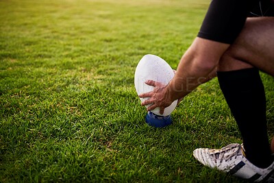 Buy stock photo Cropped shot of an unrecognizable sportsman crouching alone during rugby practice in a sports club