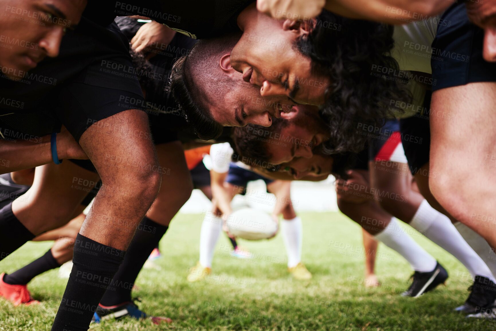 Buy stock photo Shot of a group of young rugby players in a scrum on the field