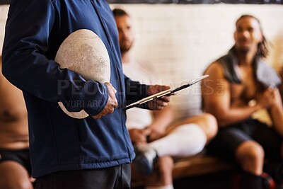 Buy stock photo Cropped shot of a rugby coach addressing his team players in a locker room