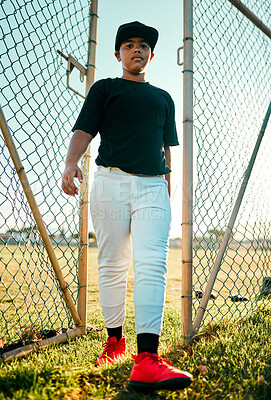 Buy stock photo Shot of a young baseball player walking through a gate