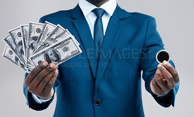 Buy stock photo Studio shot of an unrecognisable businessman holding US dollars and a bitcoin against a grey background