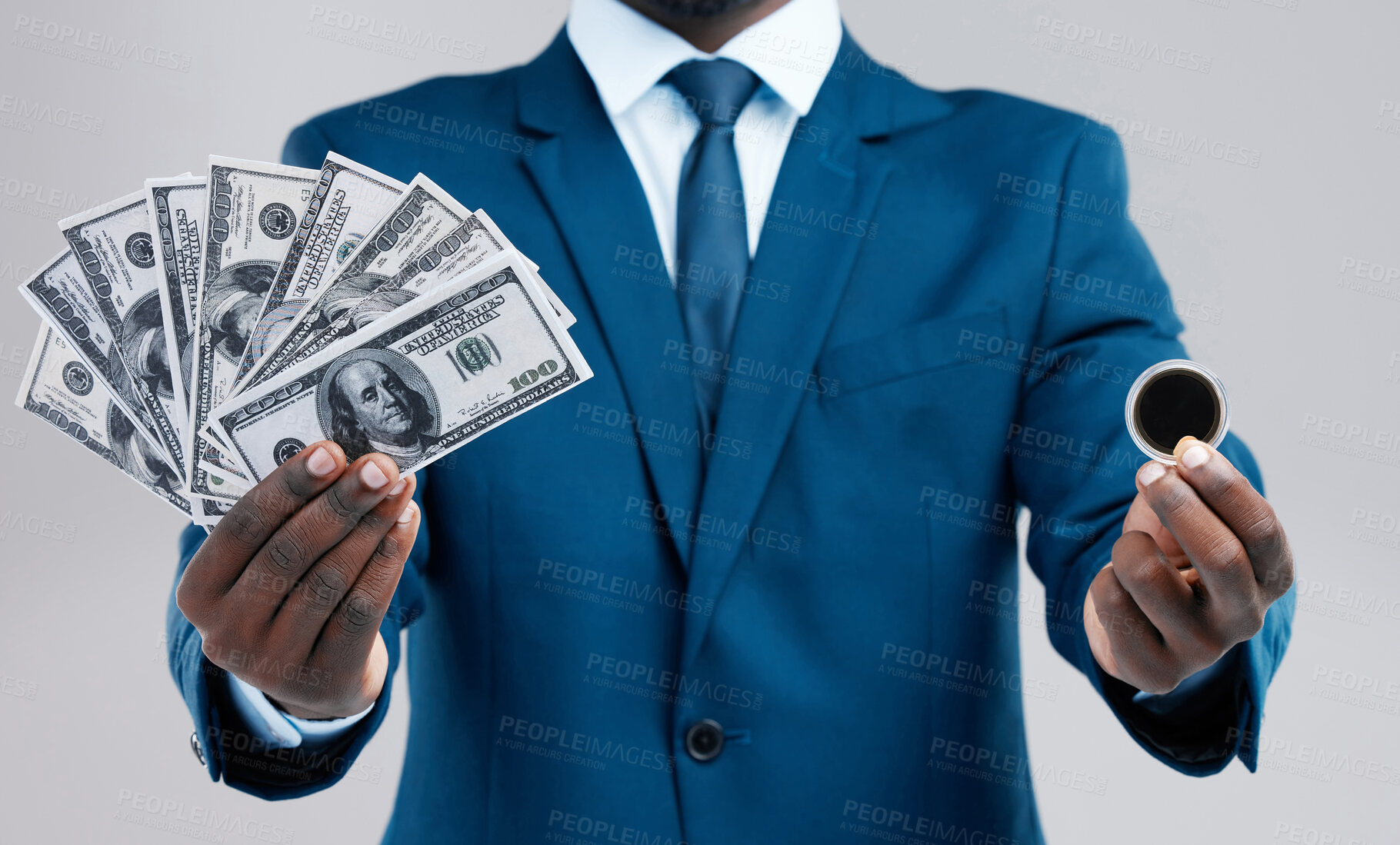 Buy stock photo Studio shot of an unrecognisable businessman holding US dollars and a bitcoin against a grey background