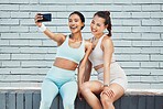 Fitness friends, happy and phone selfie for social media picture, influencer content and workout after exercise by brick wall. Fit athlete females smile for wellness, fun and motivation for internet
