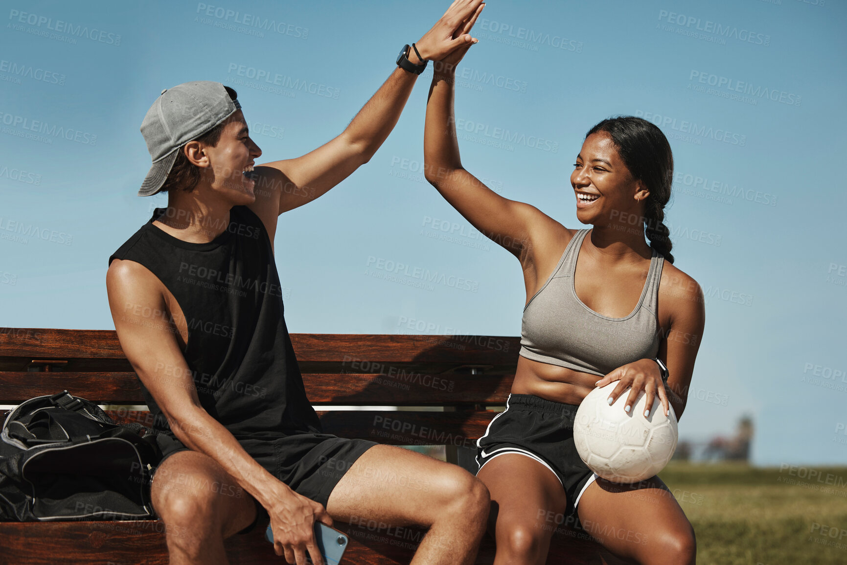 Buy stock photo High five, soccer and team celebrate winning match, happy and smile on bench with ball together. Football, players and victory enjoy game win, practice and exercise for wellness, training and workout