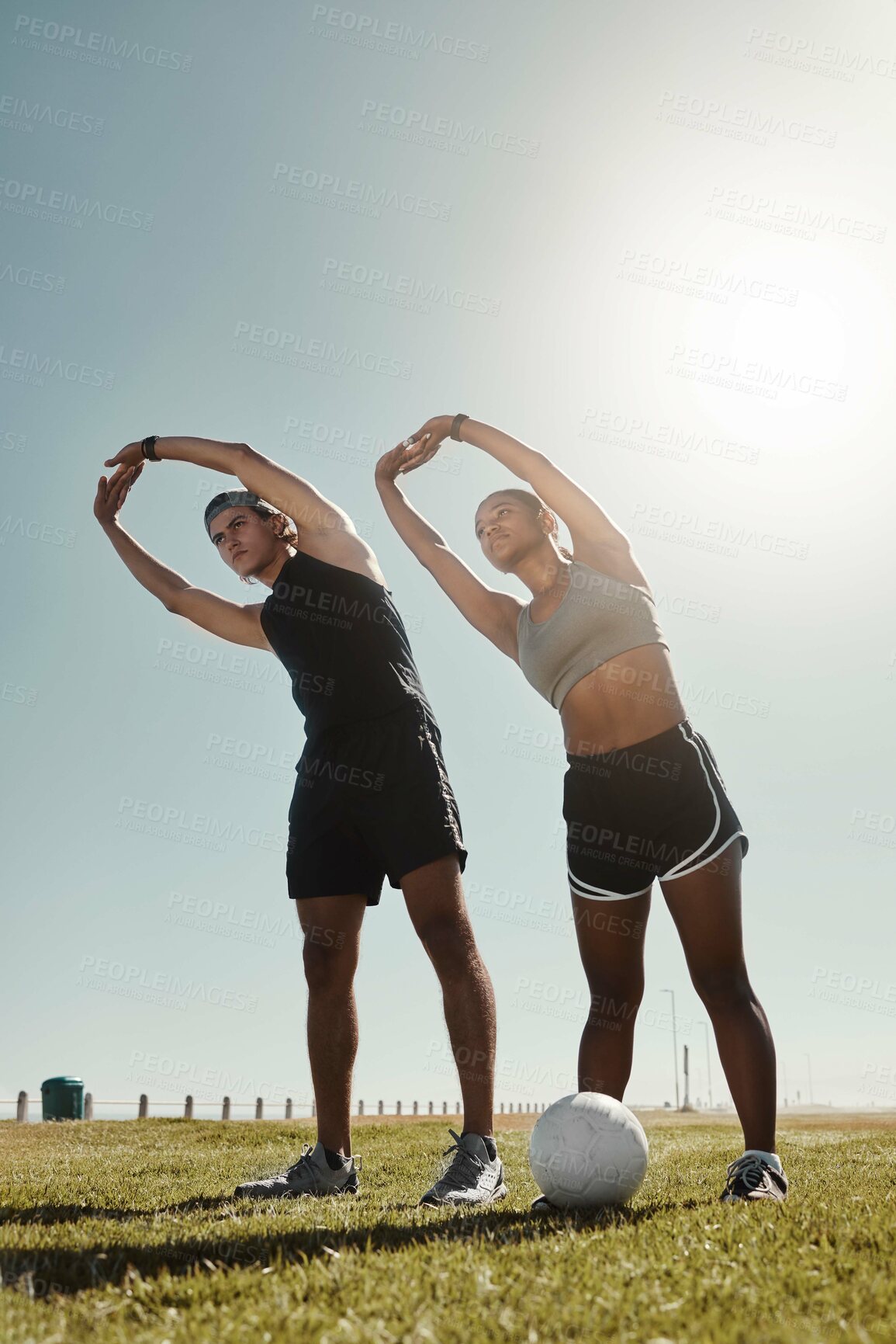 Buy stock photo Soccer couple stretching at park, people workout on outdoor football field or coach training for sports goal. Body fitness motivation together, exercise arm muscles or young athlete in Brazil