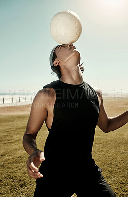 Buy stock photo Head balance, soccer and sports man in nature with a sport ball busy with football training. Fitness, workout and health exercise of a strong person on a field by the beach exercising for a game