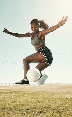 Buy stock photo Soccer, skill and athlete jumping with a ball during an outdoor match on a sports field in South Africa. Football, trick and healthy woman practicing fitness and exercise at sport training or game.