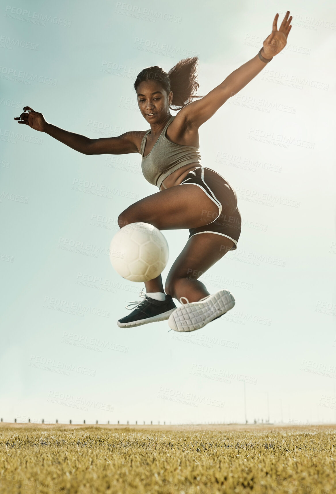 Buy stock photo Soccer, sport and black woman training on a field for competition, cardio and fitness during summer. Young, focus and African athlete doing a trick during football exercise on sport ground or park