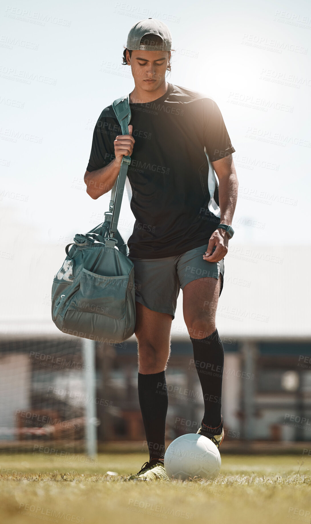 Buy stock photo Football, training and exercise man with ball on sport field after training, practice and workout with bag. Athlete, soccer and fitness on sports ground after healthy sports cardio outdoor in summer