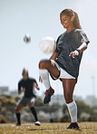 Football, sports and training with woman juggling with knees for workout, exercise and fitness on field. Health, wellness and practice with athlete and soccer ball for game, goals or cardio lifestyle