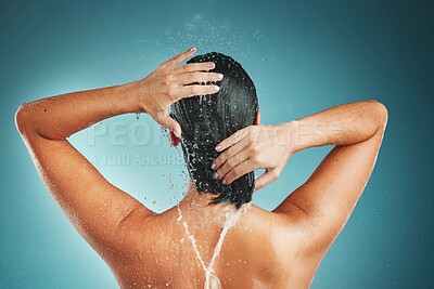 Buy stock photo Hair, water splash and woman in shower for skincare, hygiene and beauty in a studio with mockup. Hands, hair care and girl cleaning, relax and grooming, hygiene and morning routine on blue background