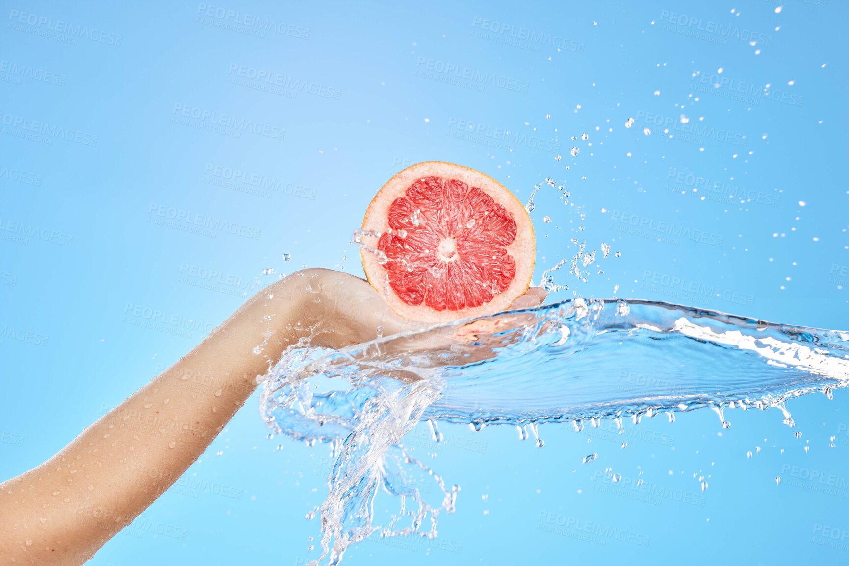 Buy stock photo Water splash, grapefruit and woman, hand and studio for wellness, health and skincare mockup, studio or blue background. Splash, citrus fruit and model hands for food diet and nutrition skin product 