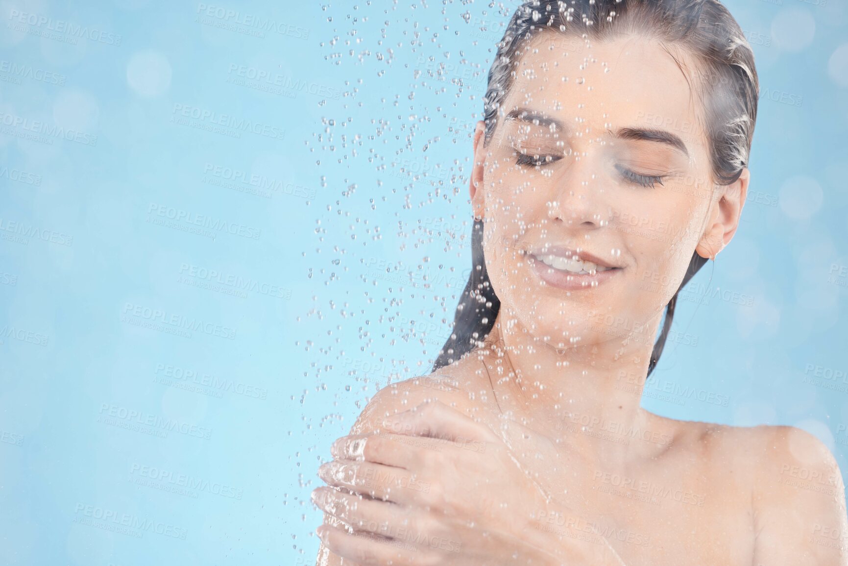 Buy stock photo Shower, cleaning and woman with water in studio for spa wellness, body care and self care on blue background. Bathroom, skincare and water drops on girl washing body for hygiene, hydration and health