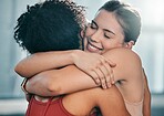 Fitness, women or friends hug at gym for support after workout, sports exercise or training. Happy girls, embrace or healthy sports people smile while hugging after exercising together for motivation