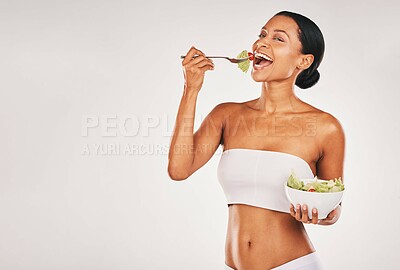 Buy stock photo Health, eating or woman with a salad in studio for a healthy meal, nutrition diet or digestion benefits. Body goals, lose weight or happy hungry female model with food isolated on a white background