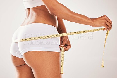 Buy stock photo Closeup, back or black woman with tape, fitness or healthy lifestyle with girl on grey studio background. Zoom, African American female or lady measure body, check size and results for target or goal