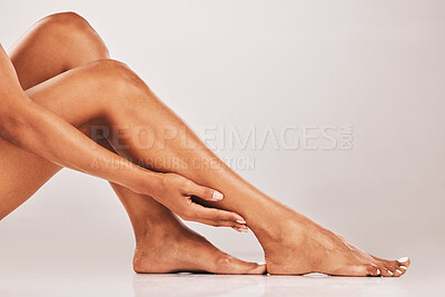 Buy stock photo Woman, hands and legs in skincare cosmetics, beauty or hair removal against gray studio background. Hand of female touching soft or gentle leg shave for healthy skin, grooming or self love and care