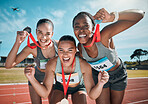 Happy women, medal and celebration in winning, running or competition together on stadium track. Group portrait of athletic people in happiness, award or victory in sports marathon or success