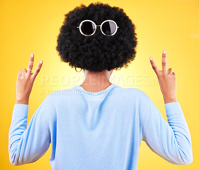 Buy stock photo Peace sign, sunglasses and afro of black woman for fashion in studio isolated on a yellow background. V hand, glasses on hair and back of African person for style, cool and funny emoji for victory