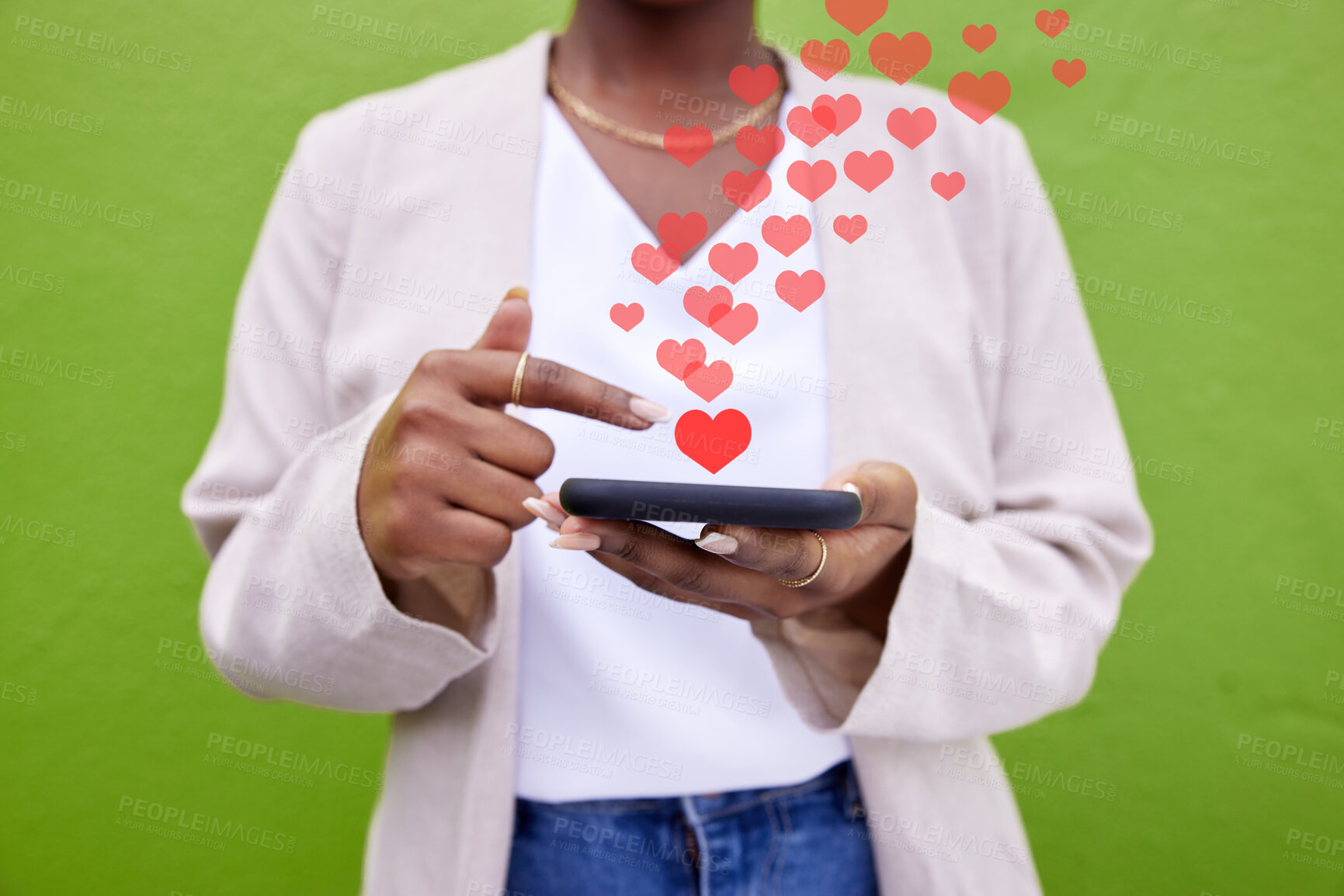 Buy stock photo Phone, hands and woman with heart icon for online media, social network or feedback on mobile app. Smartphone, closeup and user typing post, communication and love sign emoji on green background wall